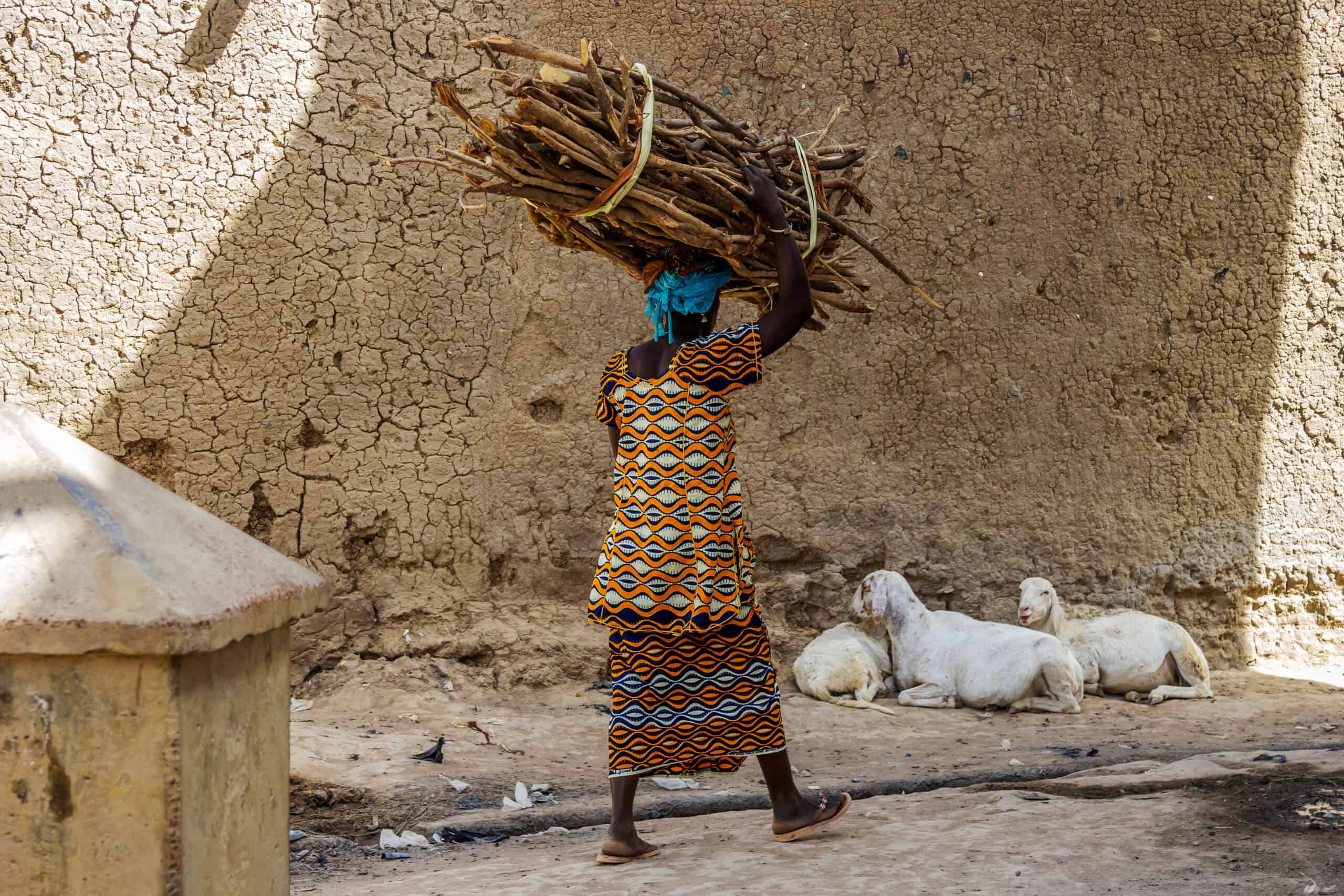African woman carrying wood